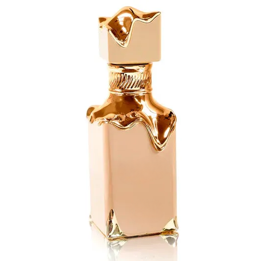 Decorative empty gold-toned bottle with melted wax design, stylish home decor accent